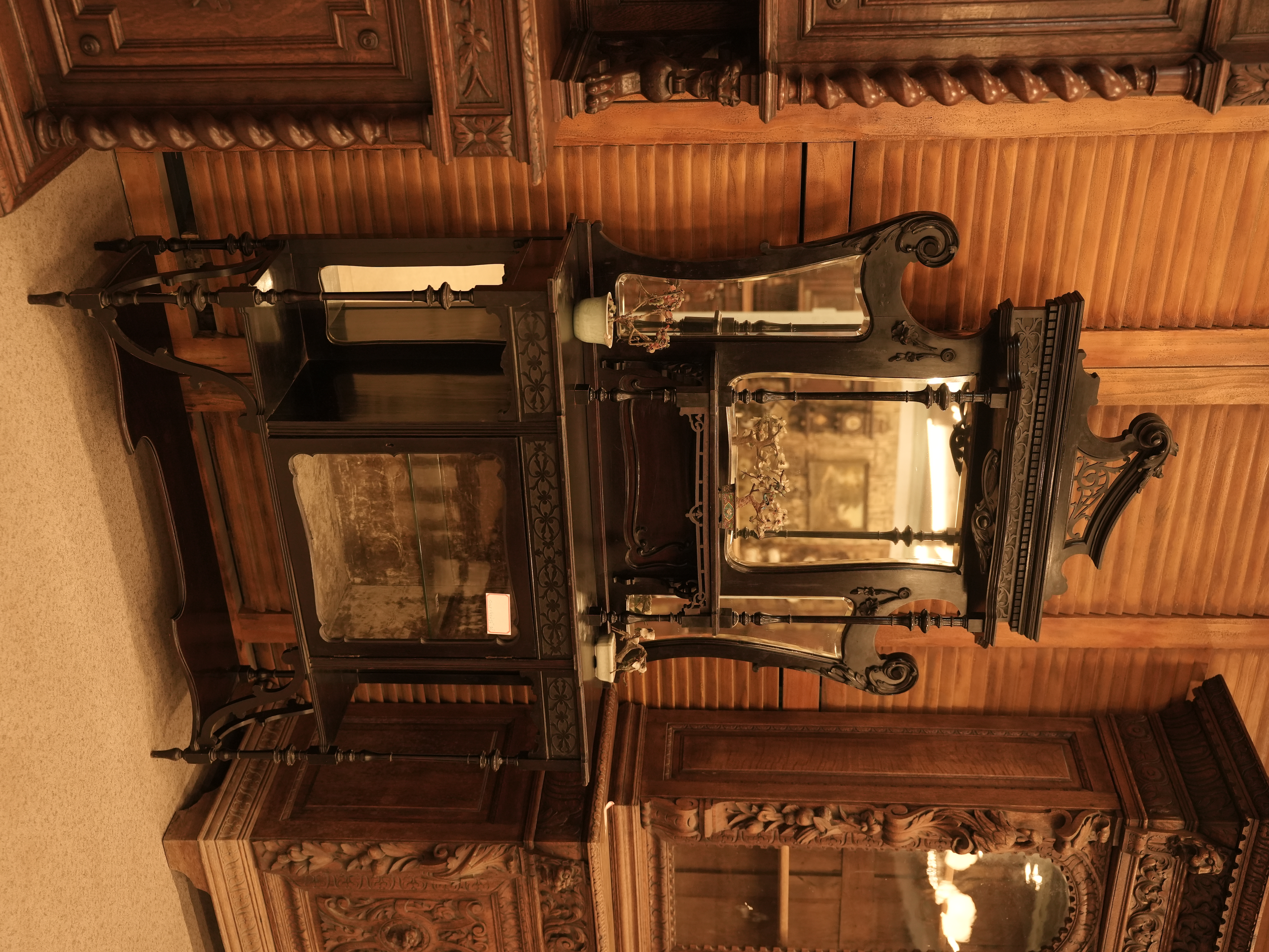 This is an antique Late Victorian English etagere display curio cabinet, likely made from carved mahogany.