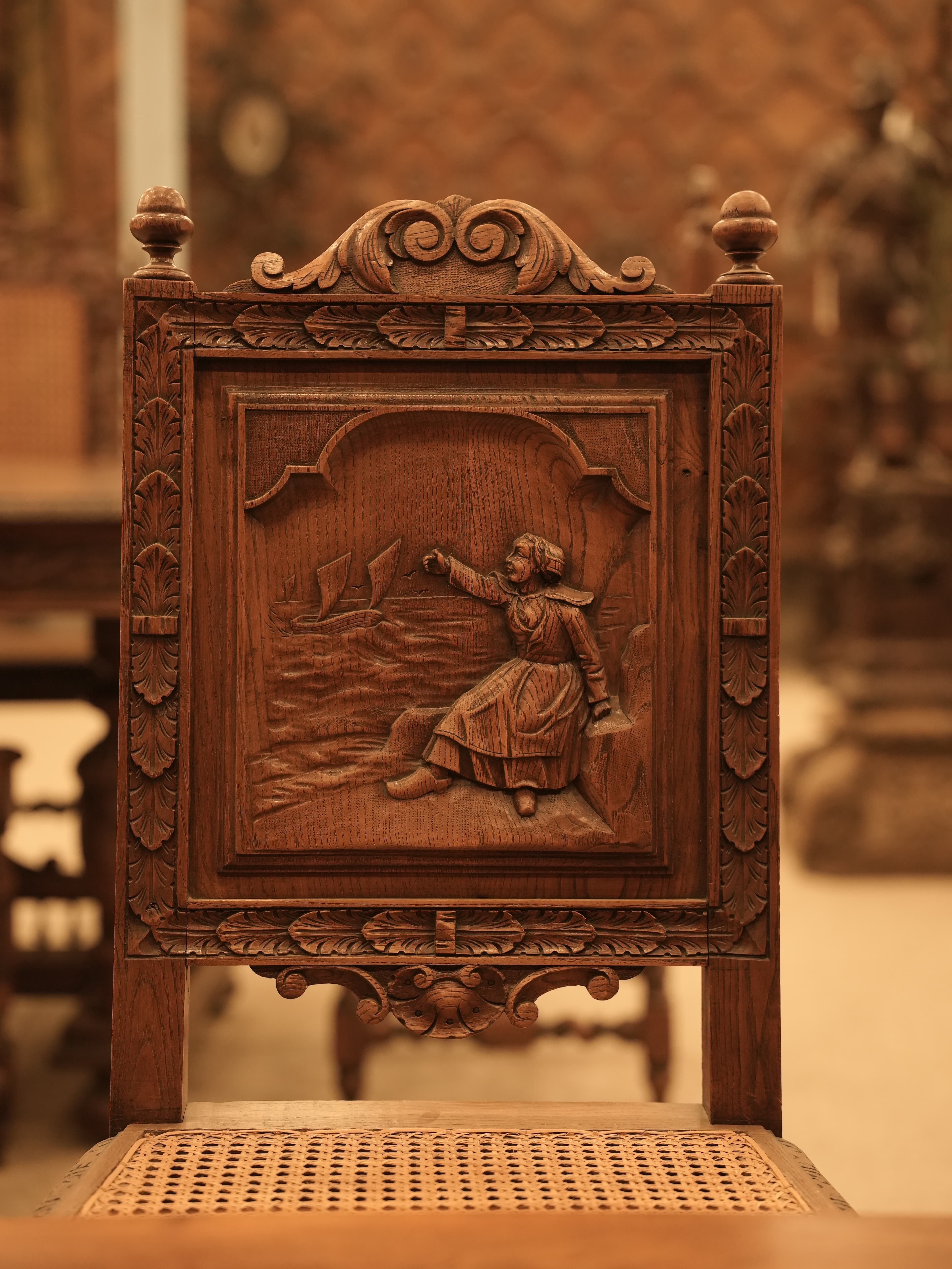 This is an antique Jacobean-style carved oak dining set.